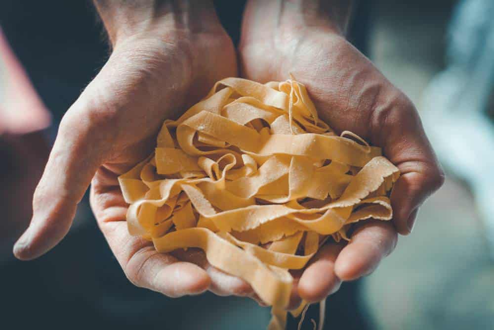 Hands Holding Pasta by Darina Kopcok