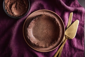 chocolate basque cheesecake on a purple linen tablecloth